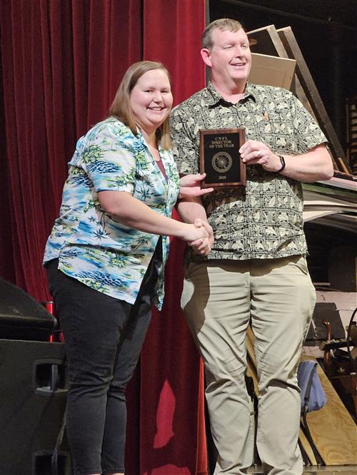 speech director presented award on stage